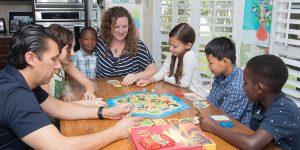 Children and their adoptive parents playing board games