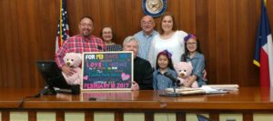 Family celebrating the adoption of two foster sisters