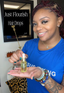 Leslye Traylor holds her beauty product, Just Flourish hairdrops